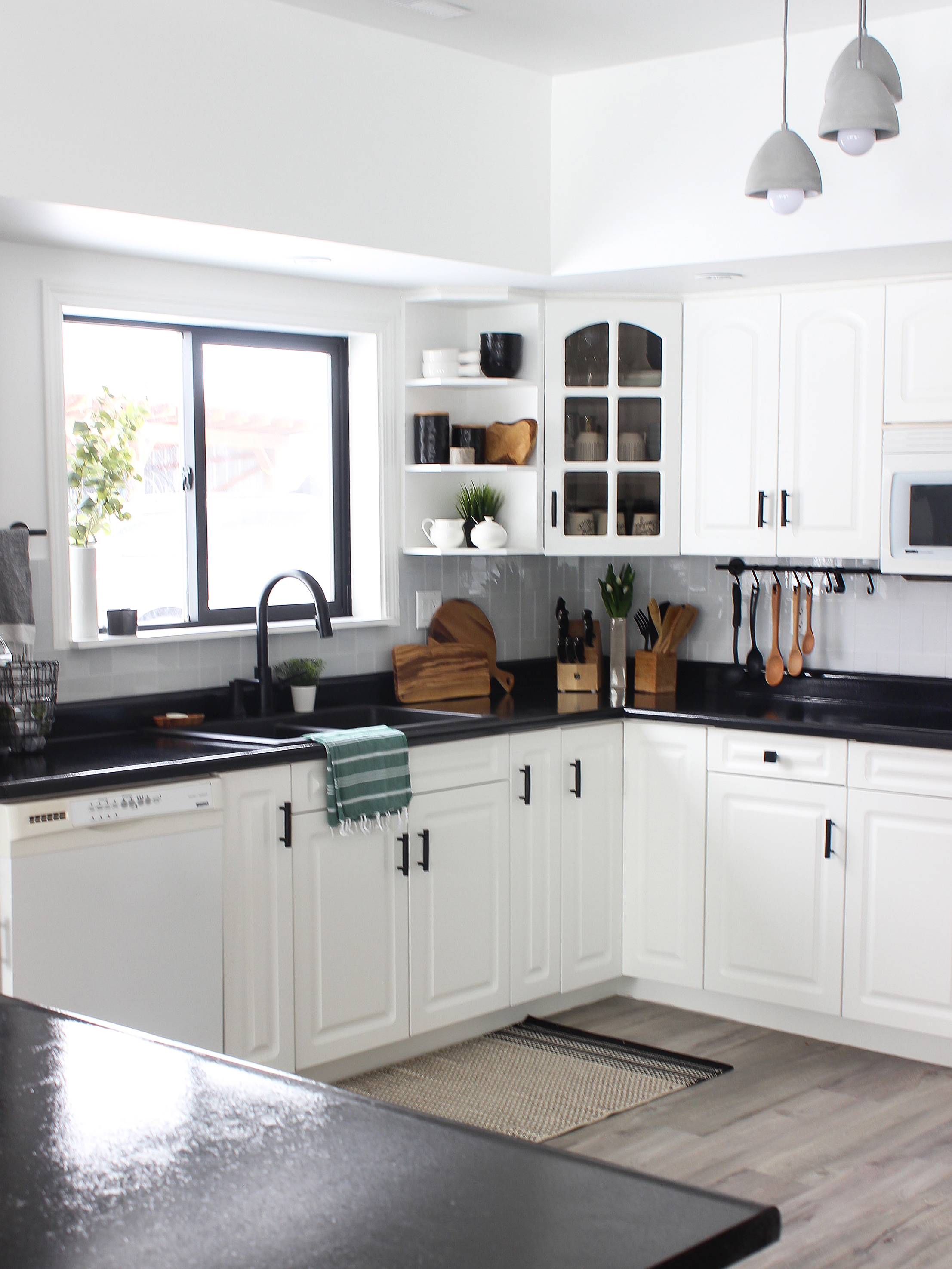 white cabinet with black countertop        <h3 class=