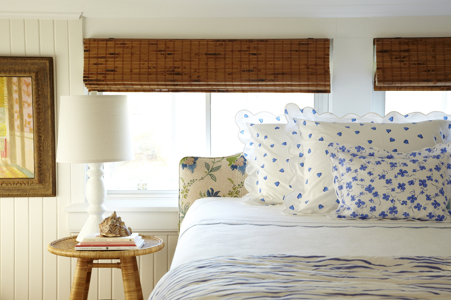 Bed with blue hearts on a pillow and blue flowers on another pillow