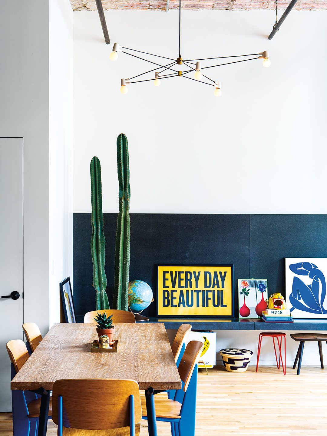 Living room with dining room table and large cactus