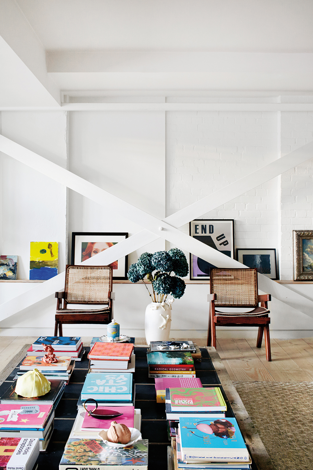 White living room with X-beam crossing in front of art