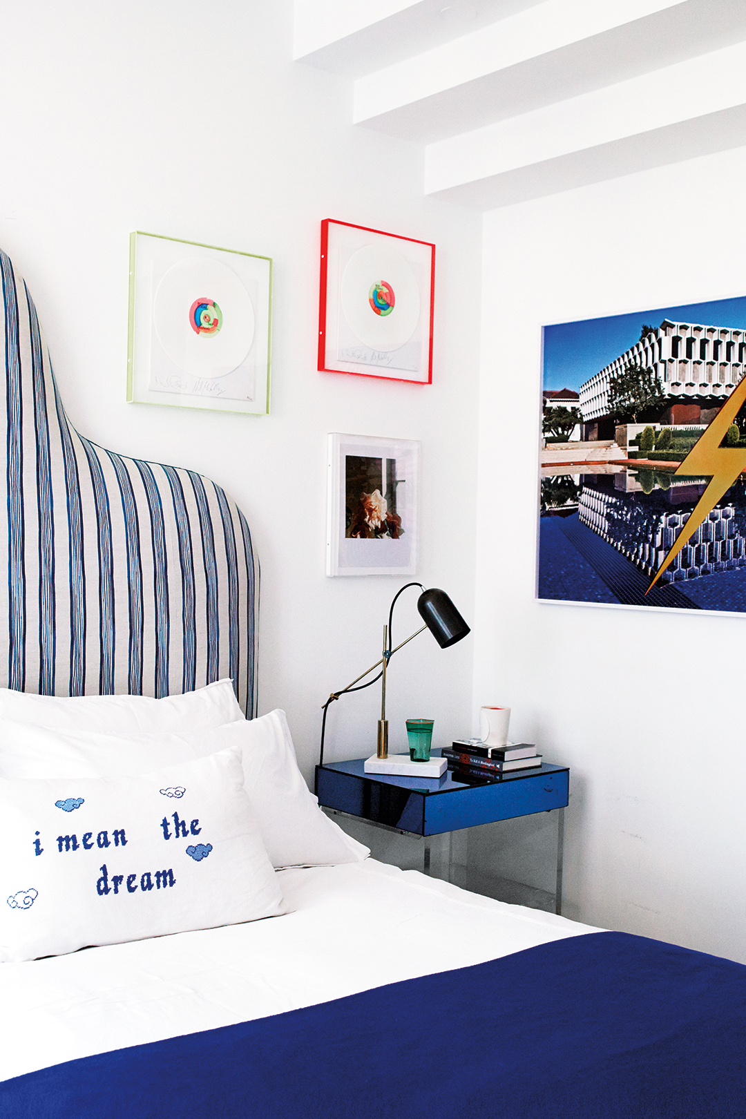 Striped blue and white headboard with blue nightstand