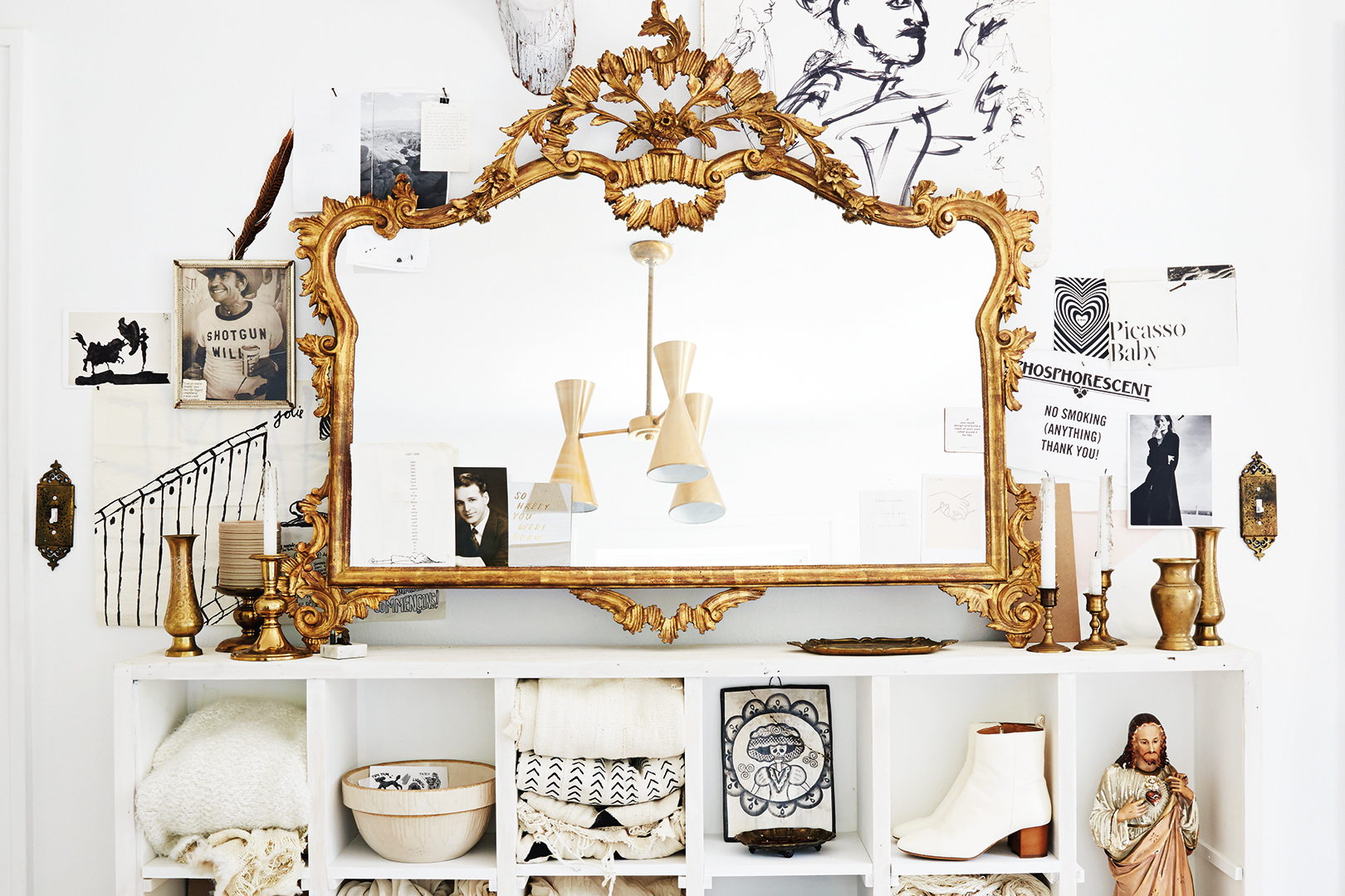 ornate gold mirror hanging above shelves