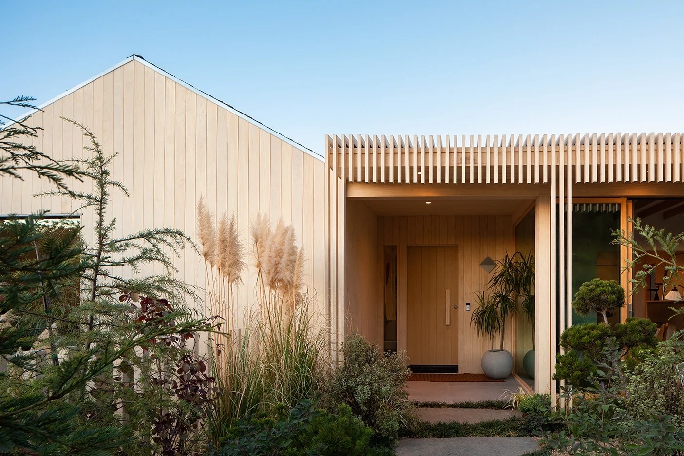 Wood house exterior with slatted wood design.