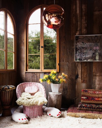 wood paneled room with pink wicker chair