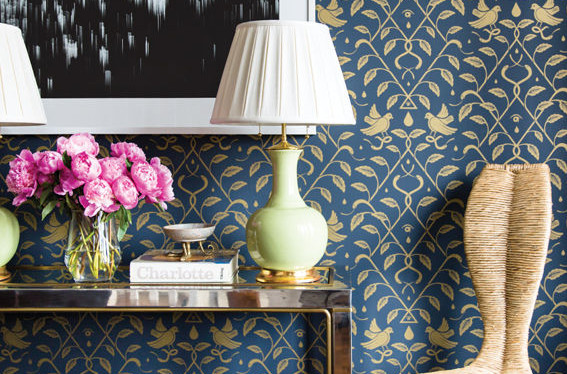console table in front of blue and gold wallpaper