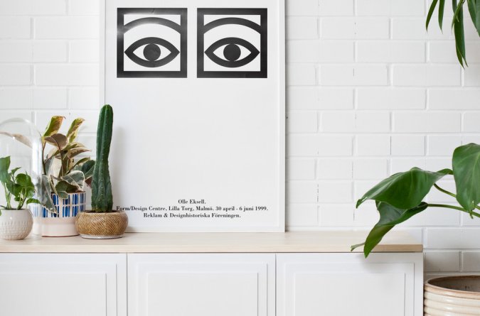 sideboard in front of white subway tile wall