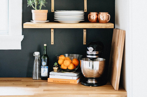 butcher block counters and black wall