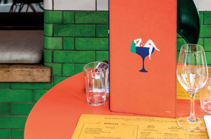 restaurant table with menu and glasses