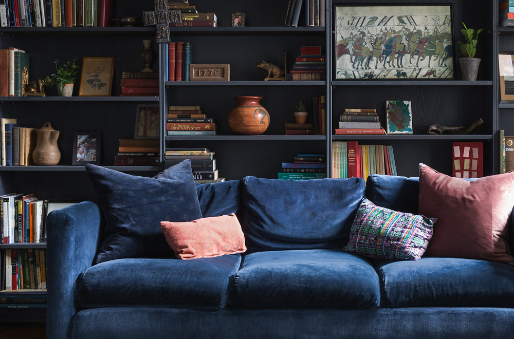 blue couch and dark blue bookcases