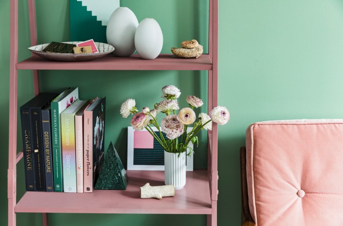 flowers and books on a shelf