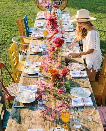 long farmhouse table with colorful floral centerpiece