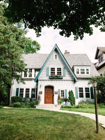 white cottage style house with dormer roof