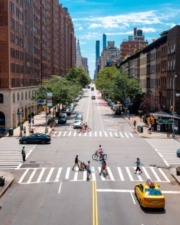 city street with people crossing crosswalk