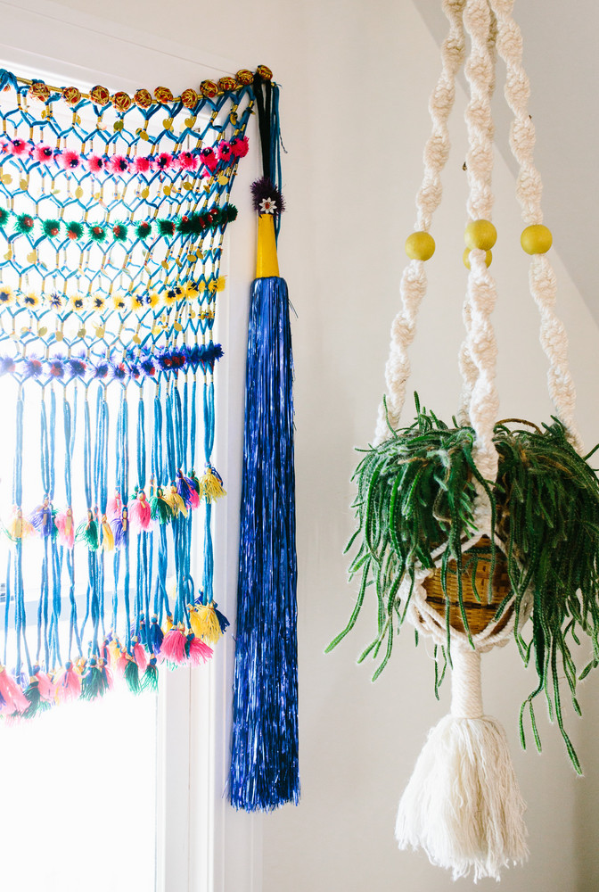 colorful macrame window covering and macrame plant holder