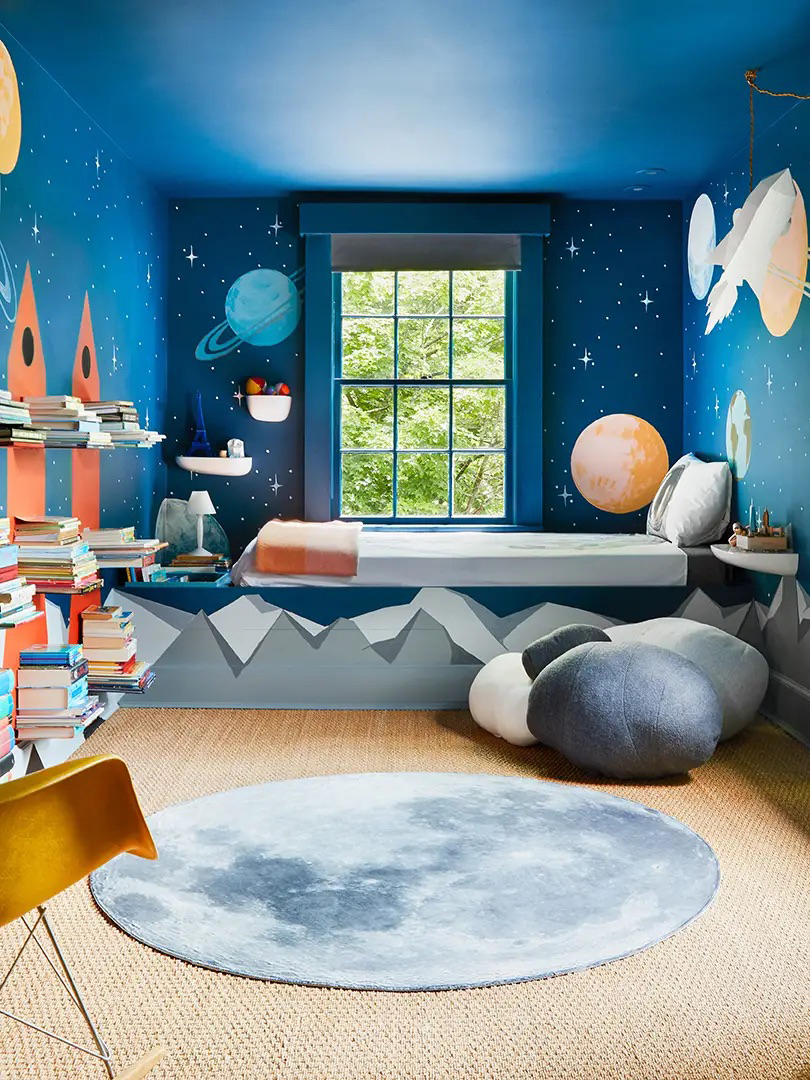 By's bedroom with dark blue outer space mural covering all walls and ceiling.