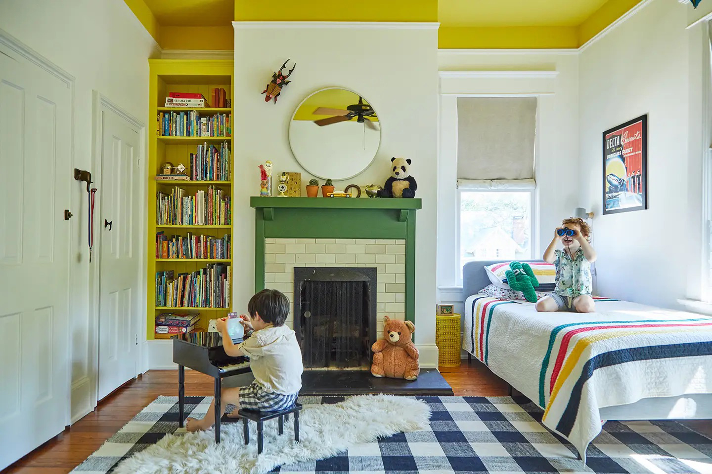 Kids' room with yellow ceiling and black-and-white checkered rug.