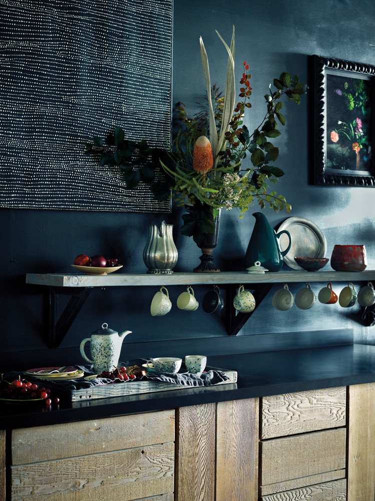 blue kitchen with dark countertops