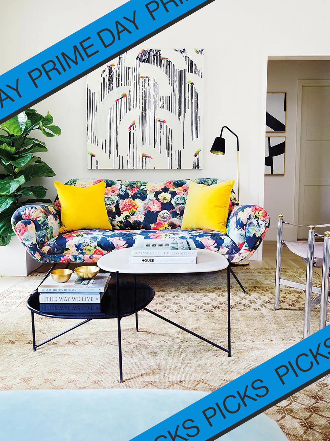 Colorfully patterned couch with yellow throw pillows in a living room.