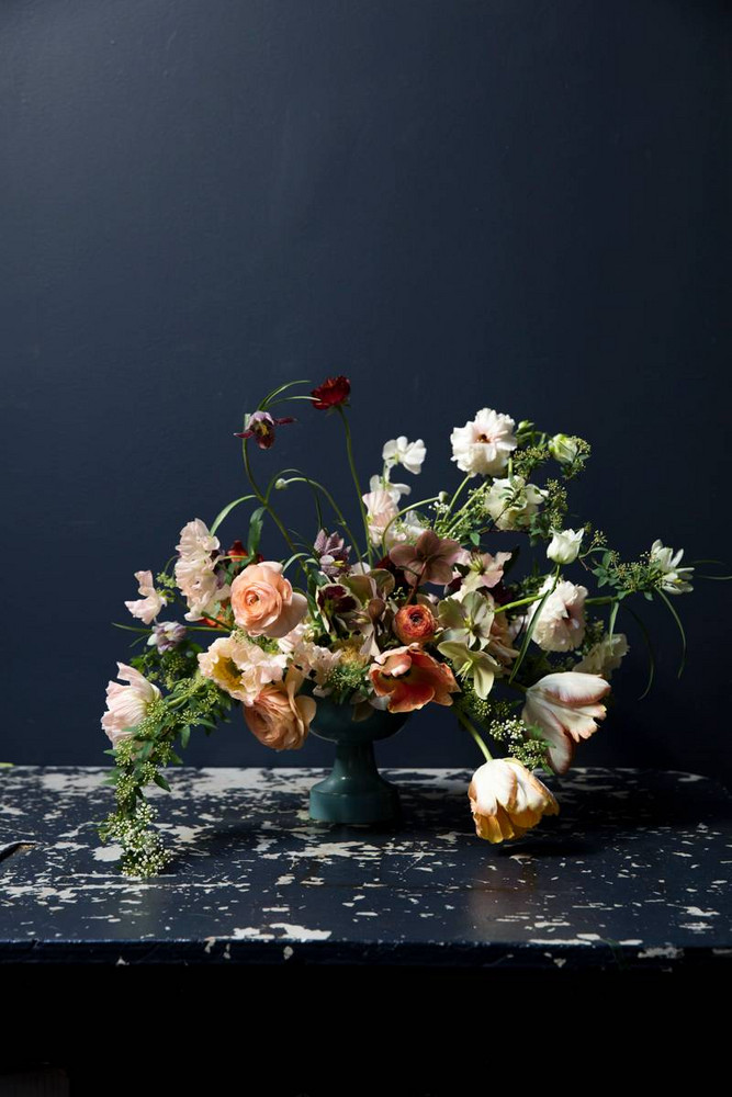 Nicolette Owen and Helen Dealtry Flower Arrangement In Front Of Blue Wall