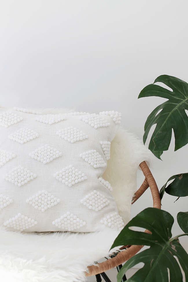 white pom pom throw pillow