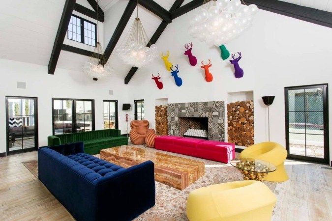 newport beach home white living room with colorful deer heads