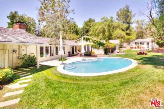 drake house white house with pool in back yard