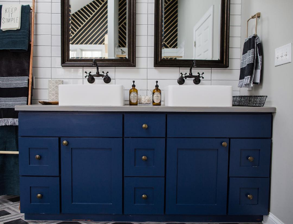 domino magazine bathroom with navy cabinets