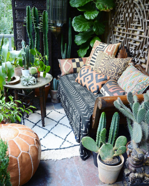 domino magazine patio with fig tree and black outdoor sofa