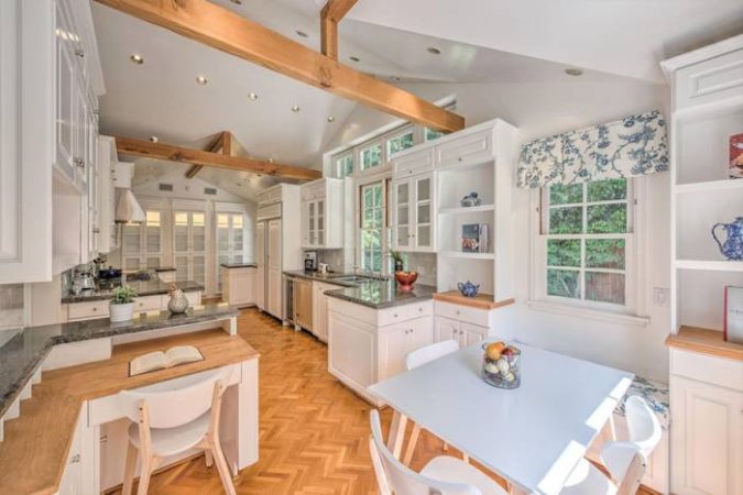 Leonardo DiCaprio home kitchen with wood beams and wood chevron floor