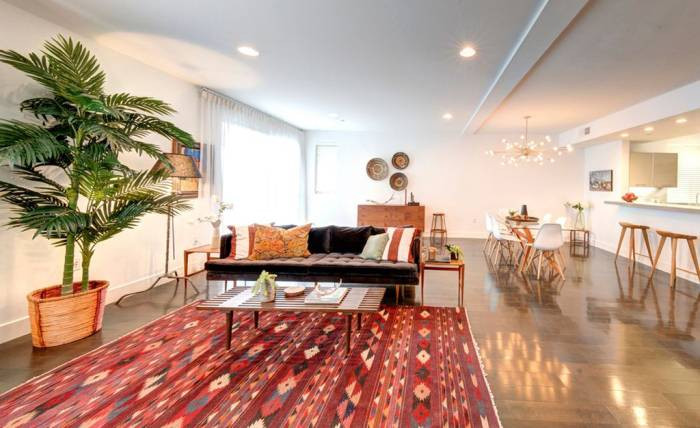 steven yeun white living room with red rug