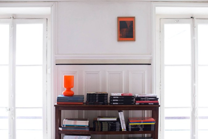 parisian interiors white wall with orange lamp