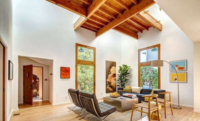 tobey maguire white living room with beam ceilings