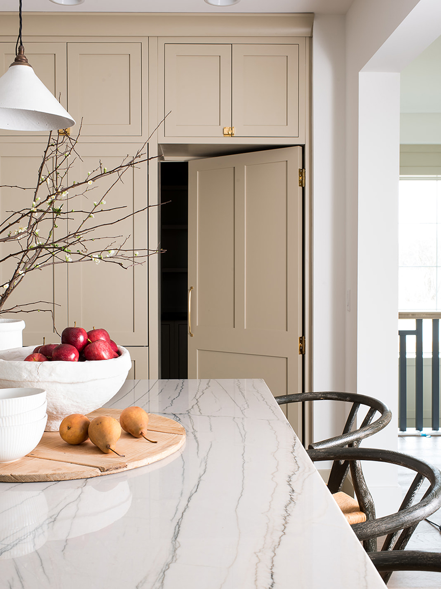 Hidden pantry door in light tan