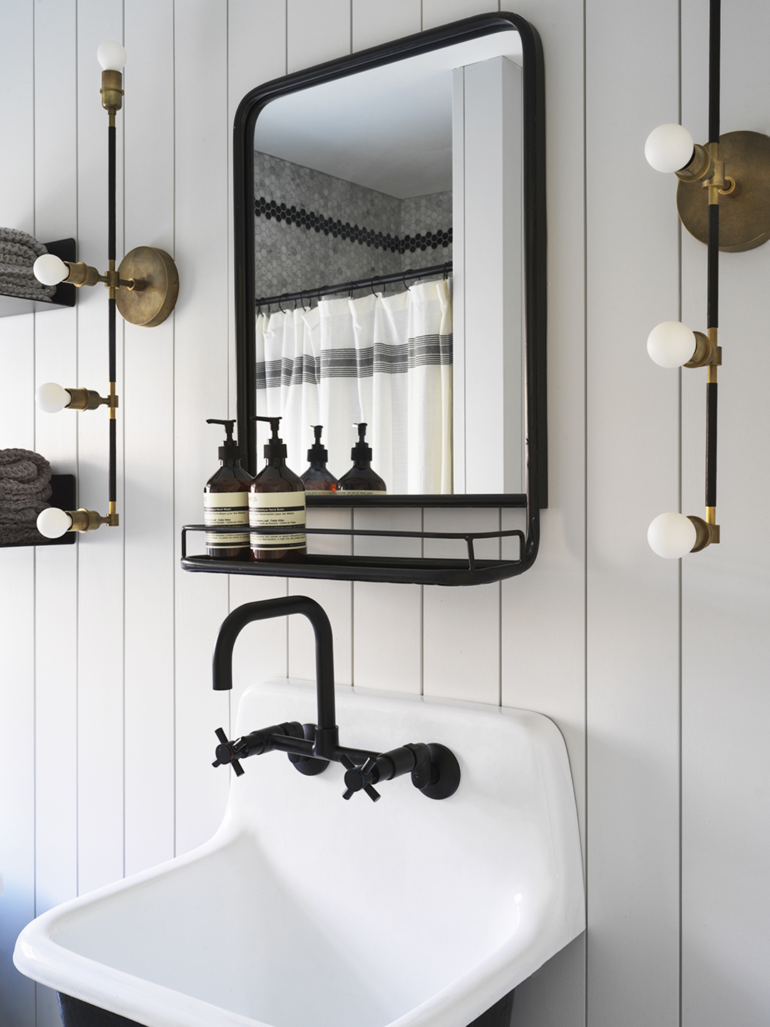 Bathroom sink with white sink and black faucet and handles