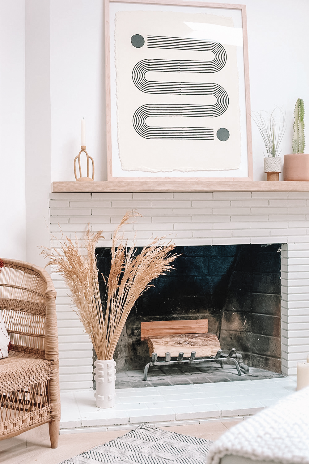 Fireplace with framed art on the mantel