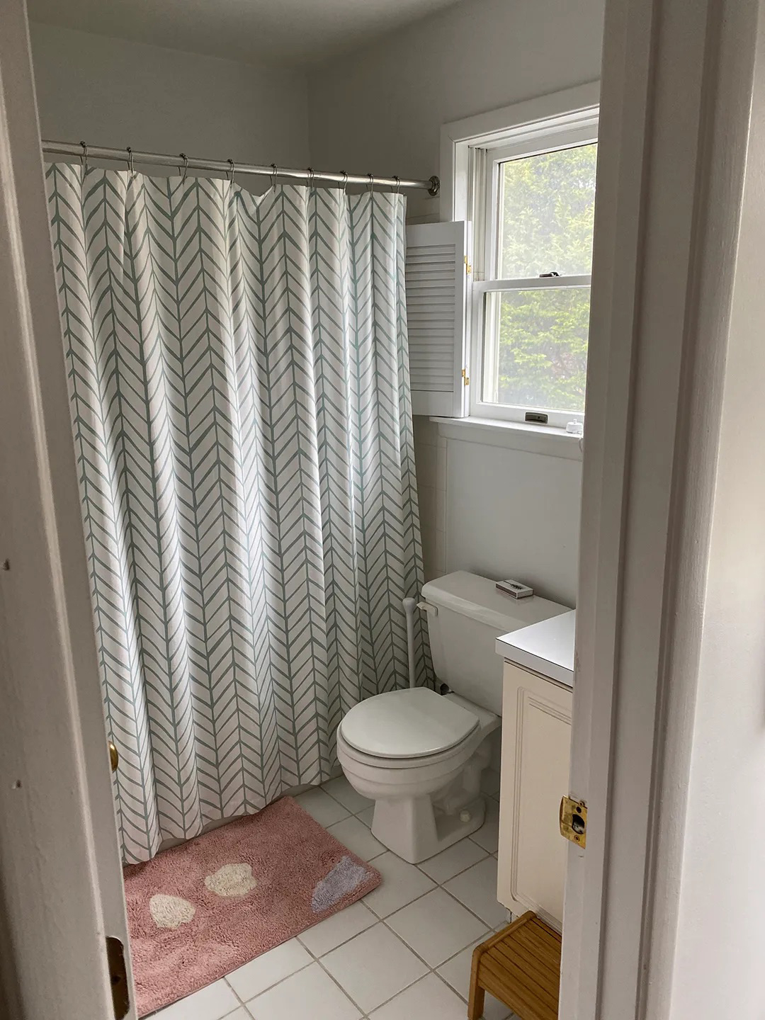 bathroom with floral shower curtain