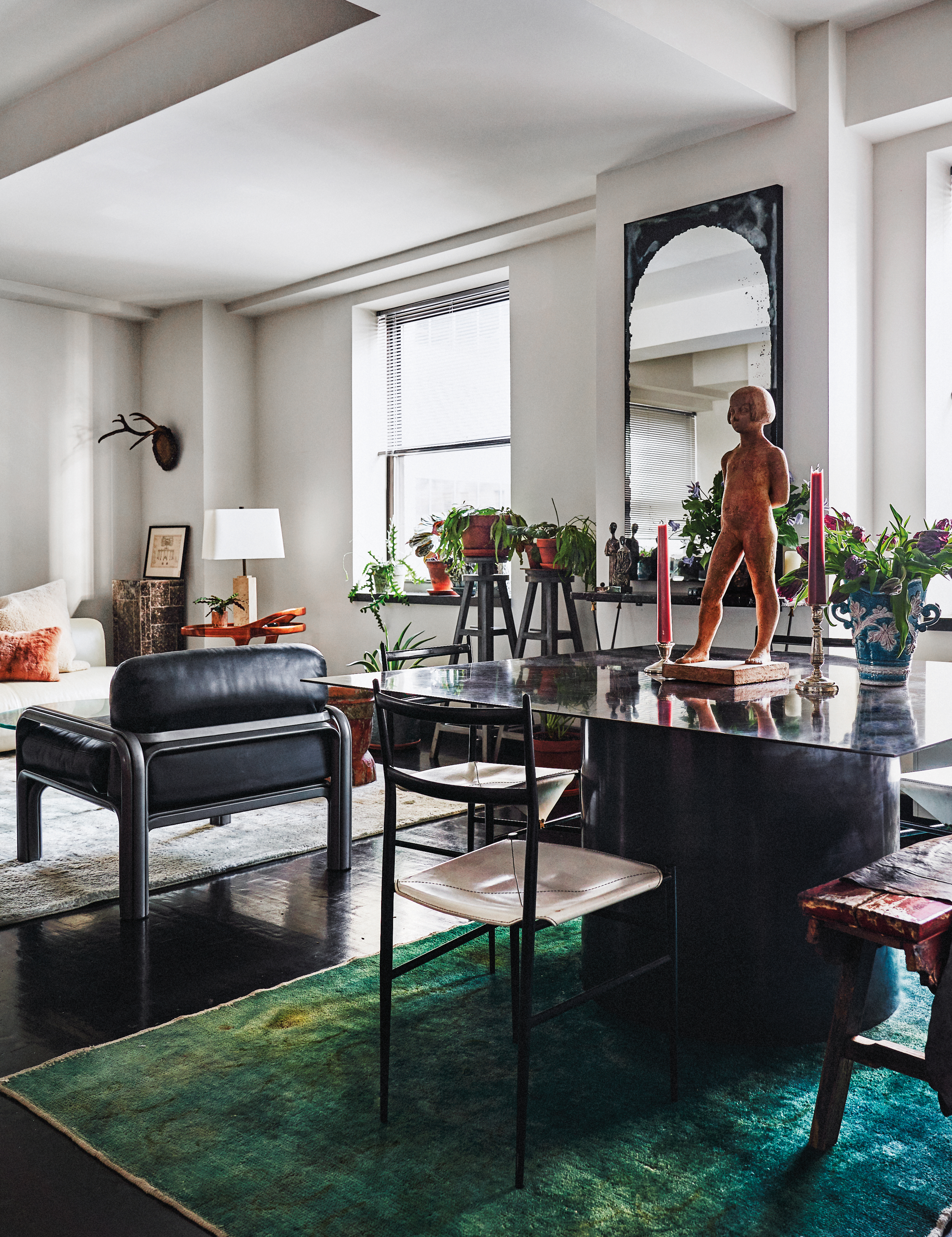 open living/dining area with green rug