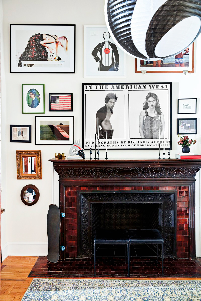 wood fireplace with gallery wall surrounding it