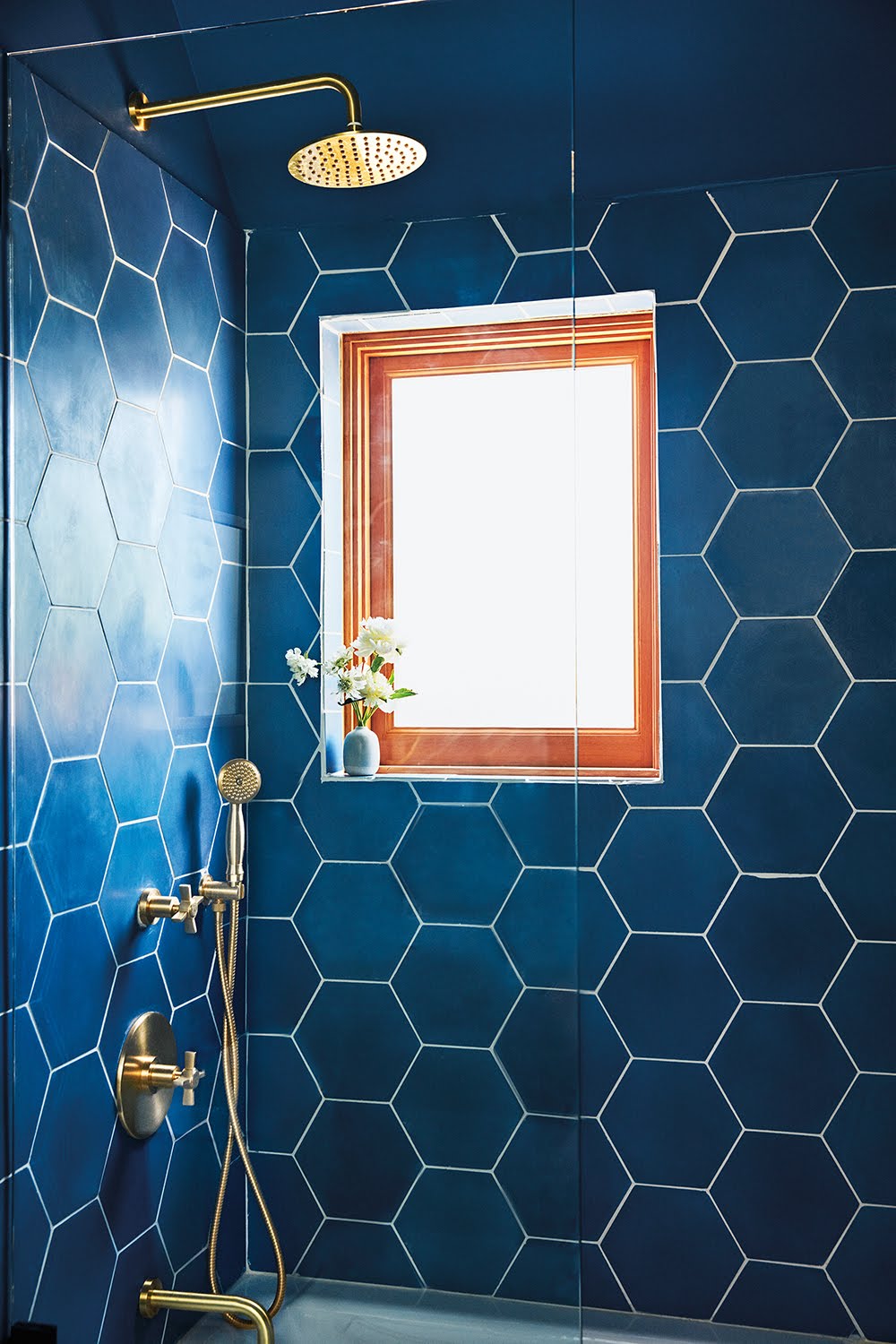 blue bathroom with hexagonal shower tiles