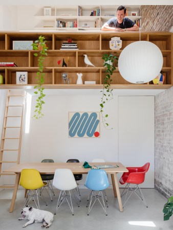 lofted office over dining table with man looking down