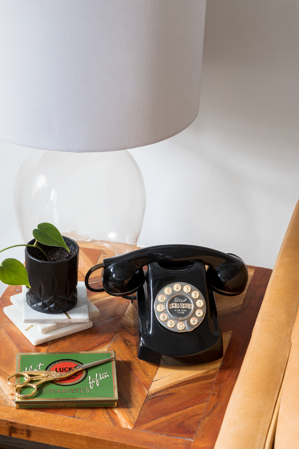 nightstand with retro phone and glass lamp