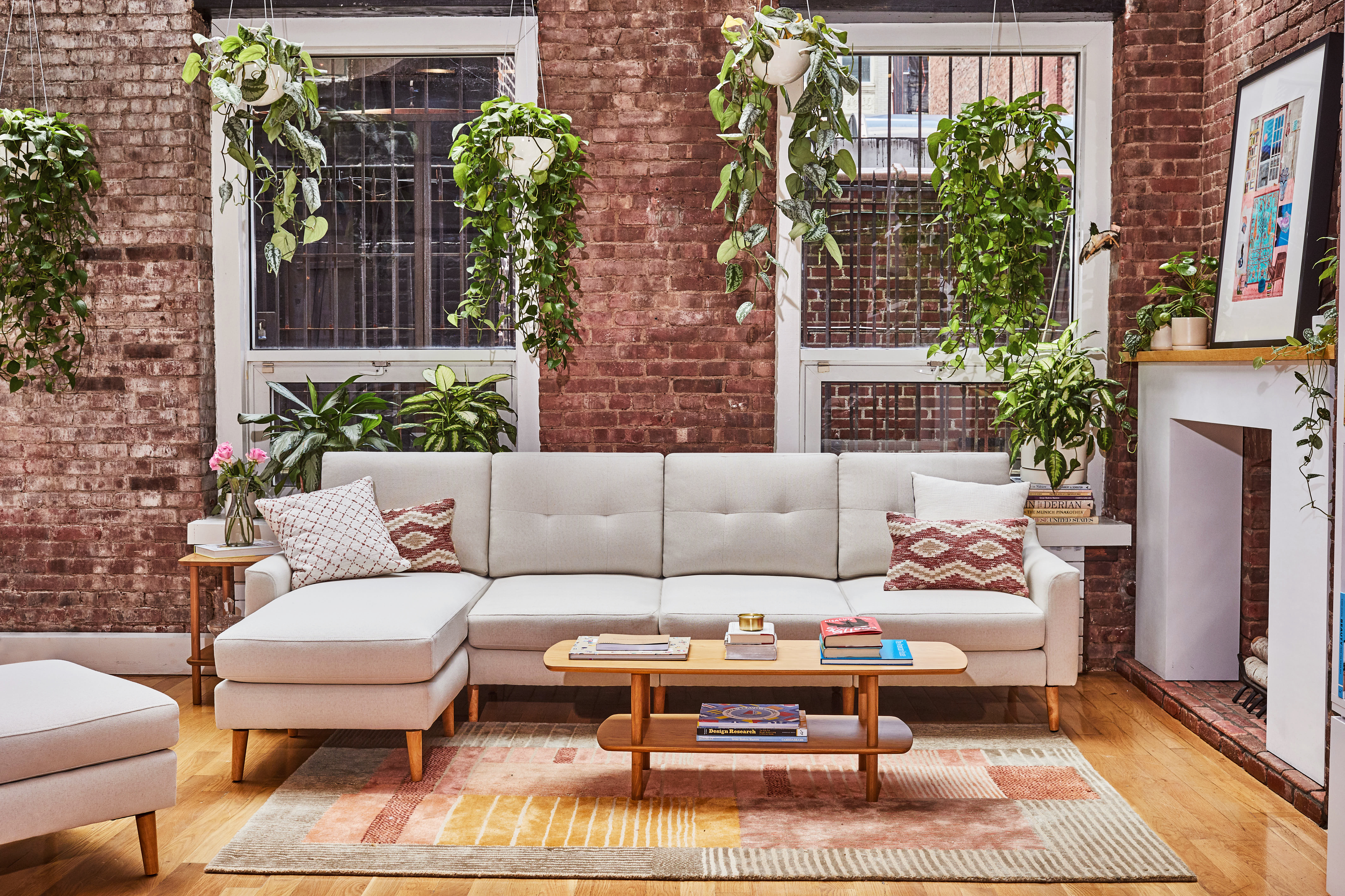 Living room with brick walls and long sofa.