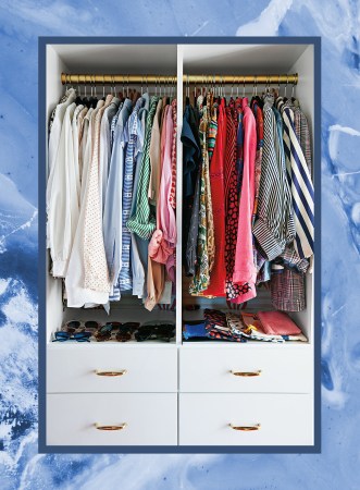 photo of a color coordinated closet on a blue backdrop