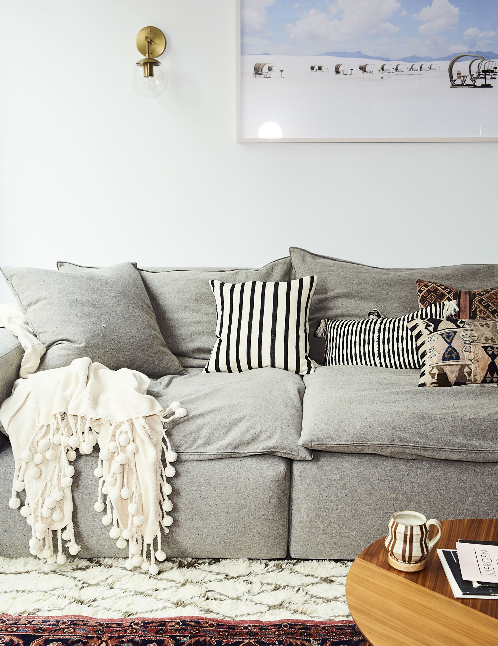 cozy gray living room sofa with a landscape print above it