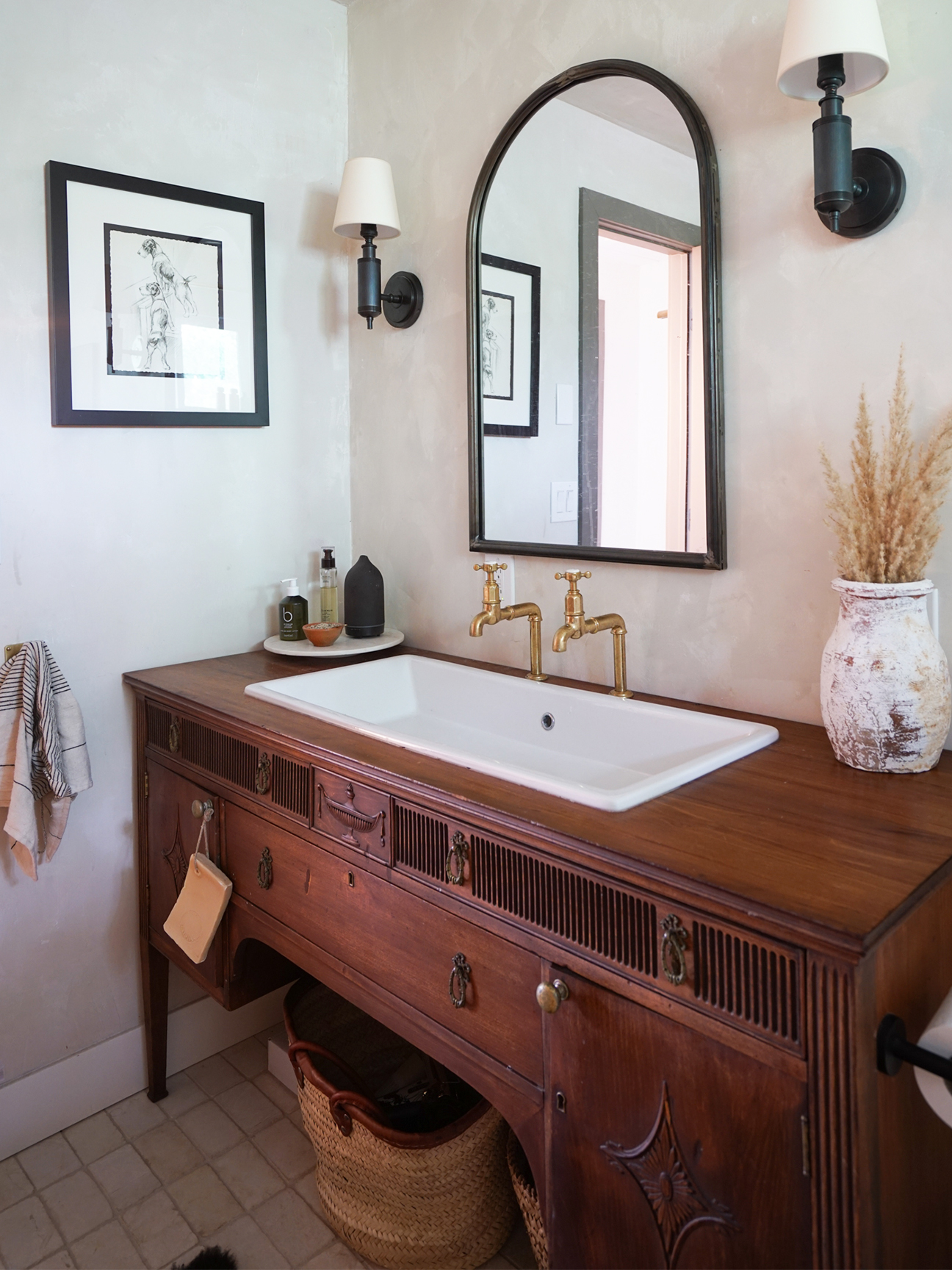 antique table repurposed as a bathroom vanity with a sink