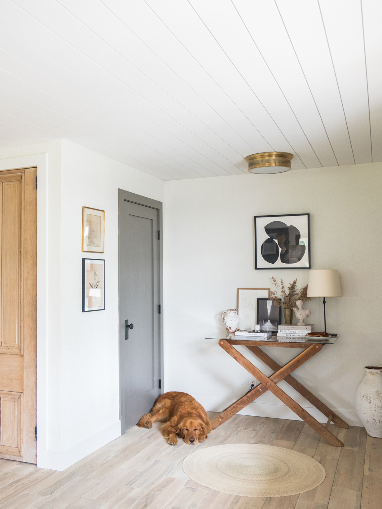 dog sleeping next to an x shaped console table