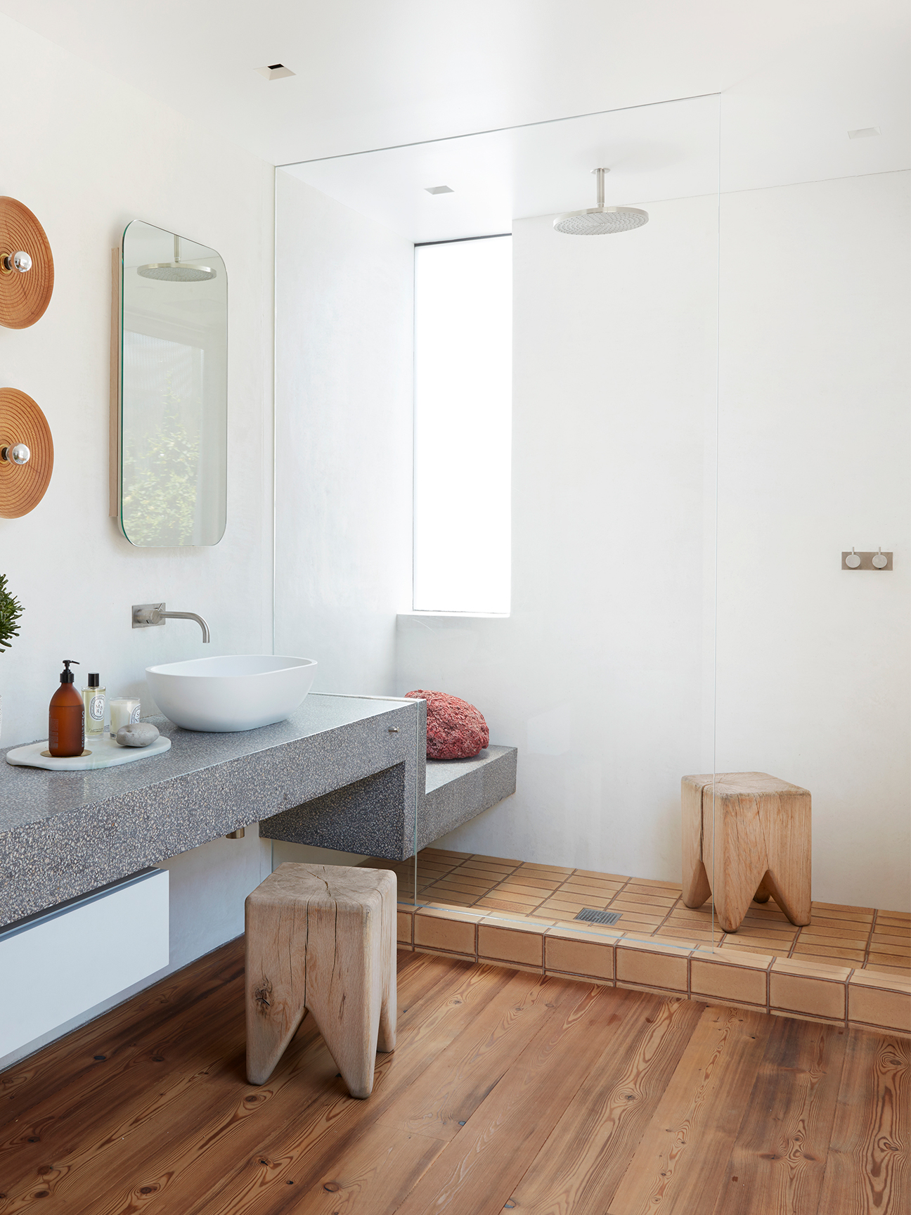 zen shower with terrazzo vanity leading into the shower bench