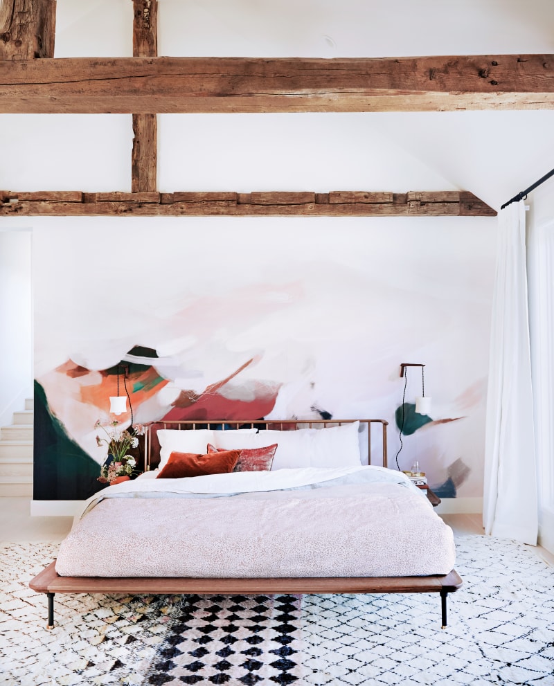 light bedroom with bed and wall mural