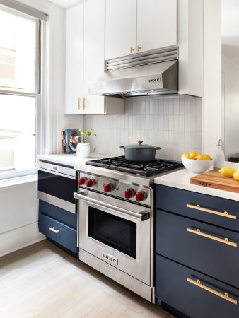 renovated kitchen with blue cabinets on the bottom and white cabinets on top