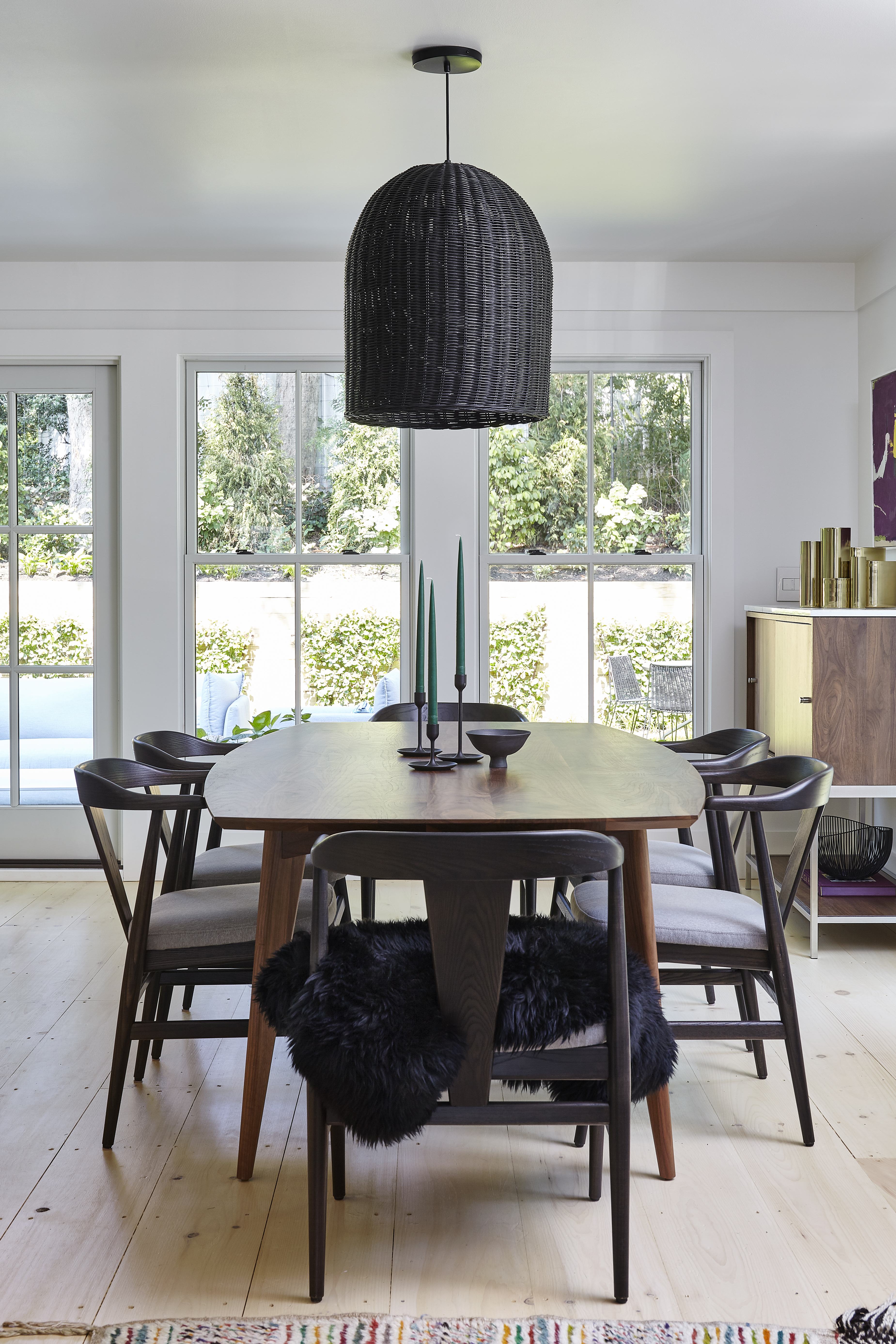 Dining room with dark mid-century modern furniture.